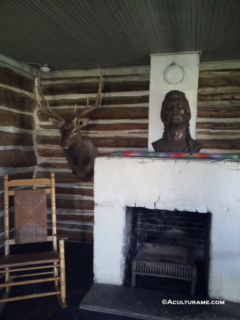 Inside Plenty Coups' log home and a bust of his likeness on display