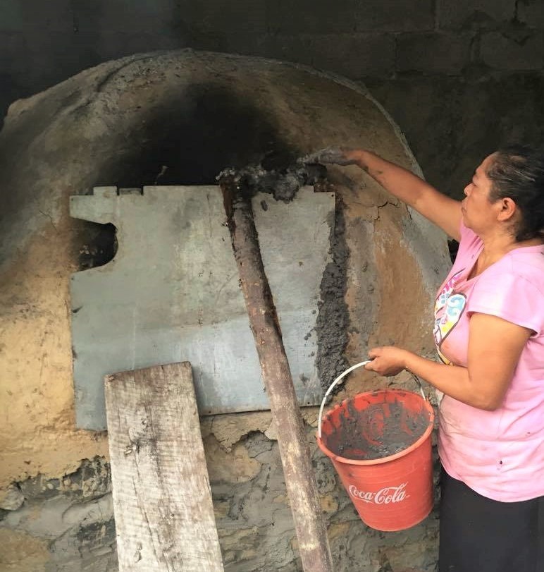 zacahuil is placed inside adobe oven and sealed with cement