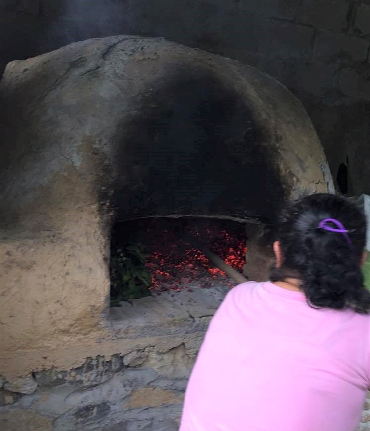 zacahuil is placed inside adobe oven to cook overnight