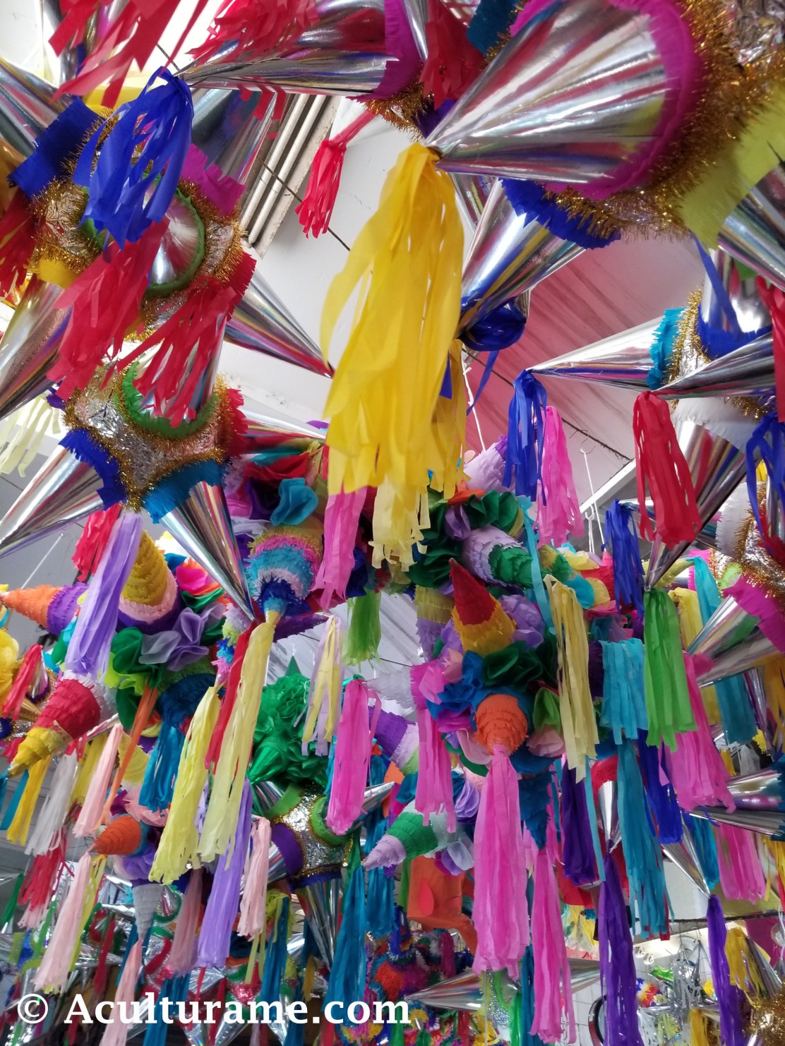 Colorful piñatas hanging on the ceiling at Mercado República.